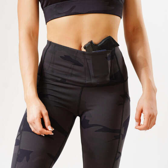Alexo Women's 7/8 Concealed Carry Leggings in Dark Night Camo, shown with sidearm.